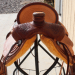 Rancher - 15.5 in, latigo, 2-tone, dark straight-back, floral, Diamond w barbed wire border, full bskt wv, strp lthrs out and tooled $2875