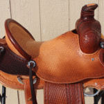 Rancher - 15.5 in, latigo, 2-tone, dark straight-back, floral, Diamond w barbed wire border, full bskt wv, strp lthrs out and tooled $2875