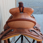 15.5 Trainer full basket weave, latigo wrap, floral conchos, dark straight-back, stirurp leathers on the outside, barbed wire w channels border