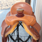 Ultimate Roper 16in, mule hide wrap, floral cochos, basket weave border tooling, stirrup leathers on the outside. Comes with choice of rawhide stirrups