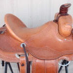 Ultimate Roper 16in, mule hide wrap, floral cochos, basket weave border tooling, stirrup leathers on the outside. Comes with choice of rawhide stirrups