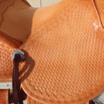 Bronc Buster - 16 in, mule hide, straight-back, full bskt wv, strp lthrs out and tooled, floral conchos, all light leather, Diamond w sswirl border - $2870