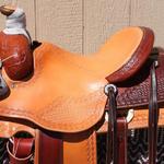 Roper - 15.5 seat, mule hide, cheyenne roll, 2-tone, floral conchos, corner basket wv, barbed wire w Santa fe diamond border, $2,400 (2)