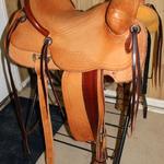 Rancher -2 strand sswirl w channels, corner basket wv, 2-tone, stirrup leathers out, corner basket weave, latigo wrap, 2 in stirrups, floral conchos, straight-back