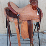 Trainer-with-2-tone-leather,-floral-conchos,-corner-Diamond-tooling,-s-swirl-with-channels-border,-cheyenne-roll,-latigo-horn-wrap,-2-in-stirrups