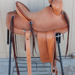 Trainer-with-2-tone-leather,-floral-conchos,-corner-Diamond-tooling,-s-swirl-with-channels-border,-cheyenne-roll,-latigo-horn-wrap,-2-in-stirrups