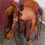 Wade - 2tone, bucking rolls, mule hide, post horn, cheyenne roll, basket wv border and corners, strrp lthrs out and tooled, breaststrap, floral